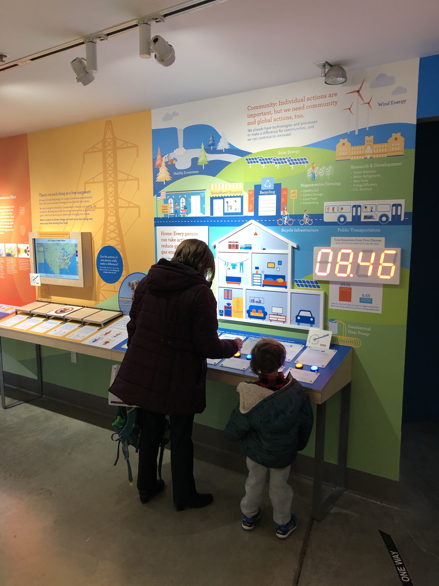 Photo of an adult and child looking at a museum exhibit.