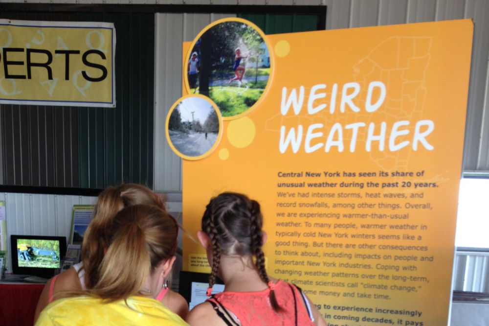 Photo of a few teenagers looking at an exhibit.