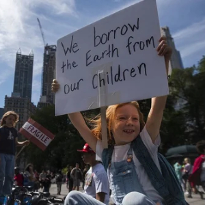 Child holding up a sign in a protest